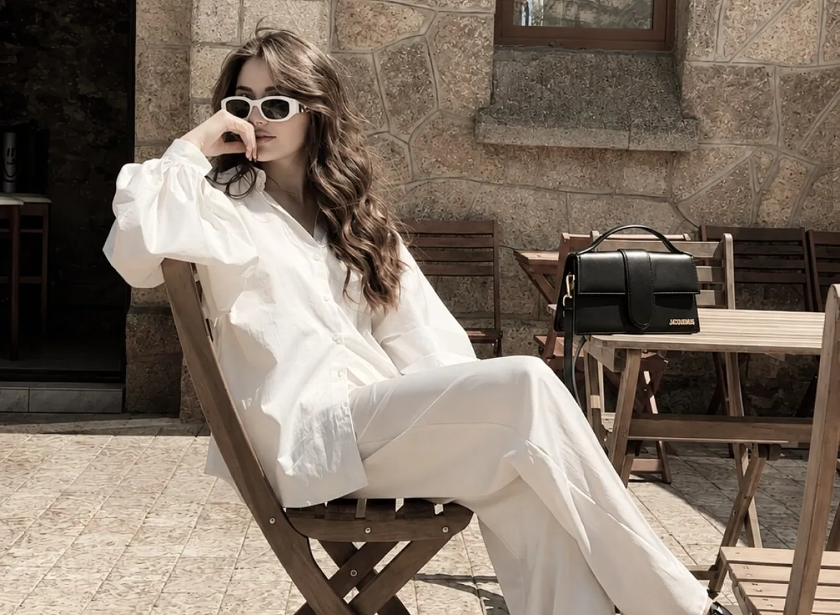 A client in a white shirt and trousers at an outdoor cafe