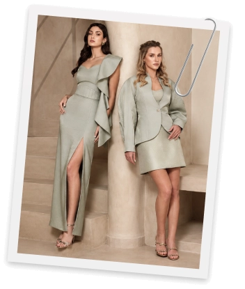 Two models in sage green looks on stone steps