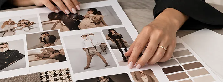 Printed looks and a colour palette spread out on a desk